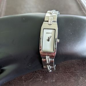 DKNY stainless steel ladies watch with white face and CZs